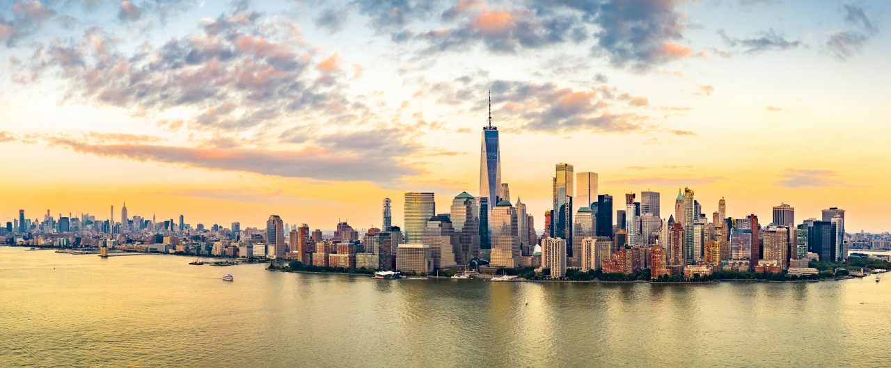 Aerial panorama of New York City skyline at sunset with both midtown and downtown Manhattan